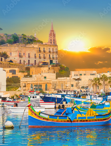 Obraz na płótnie Marsaxlokk village harbor of Malta, illuminate by sunset light w salonie