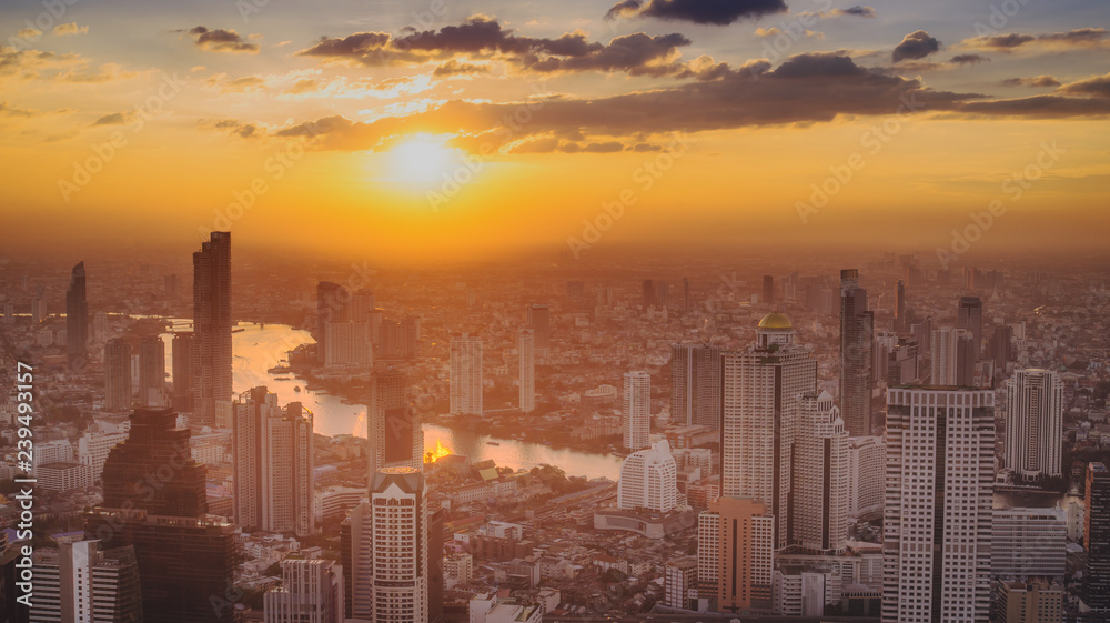 Bangkok City skyline with urban skyscrapers at sunset,City during warm sunset .