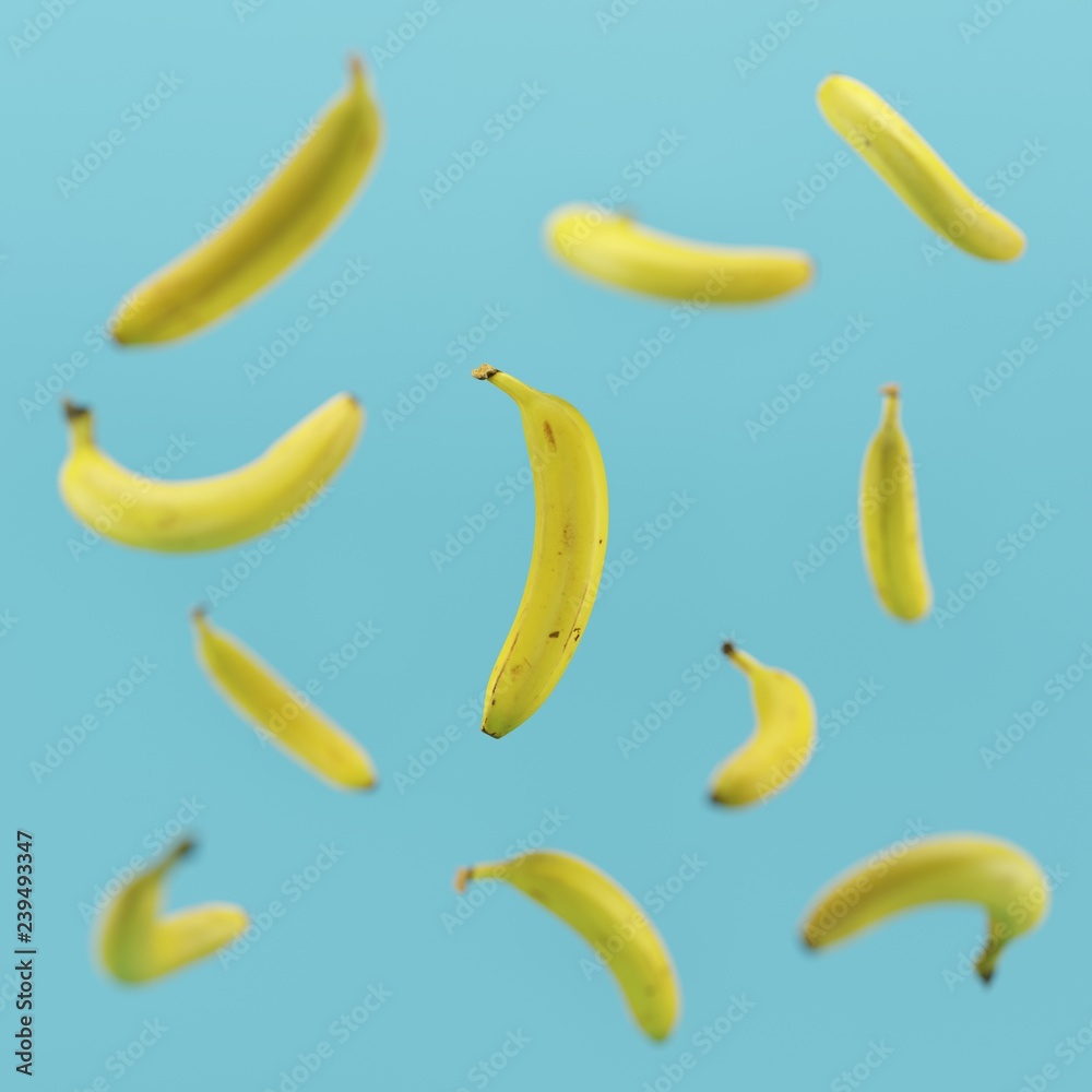 Minimal concept yellow banana floating on blue background 