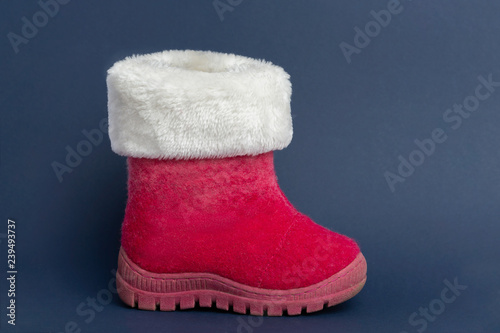 'Schoentje zetten', a traditional view for the Dutch holiday 'Sinterklaas'. Red winter boot on blue background photo