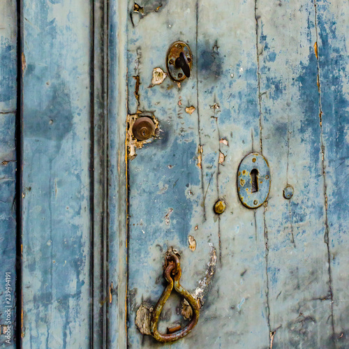 Close up of a door with three ancient locks and an old knocker