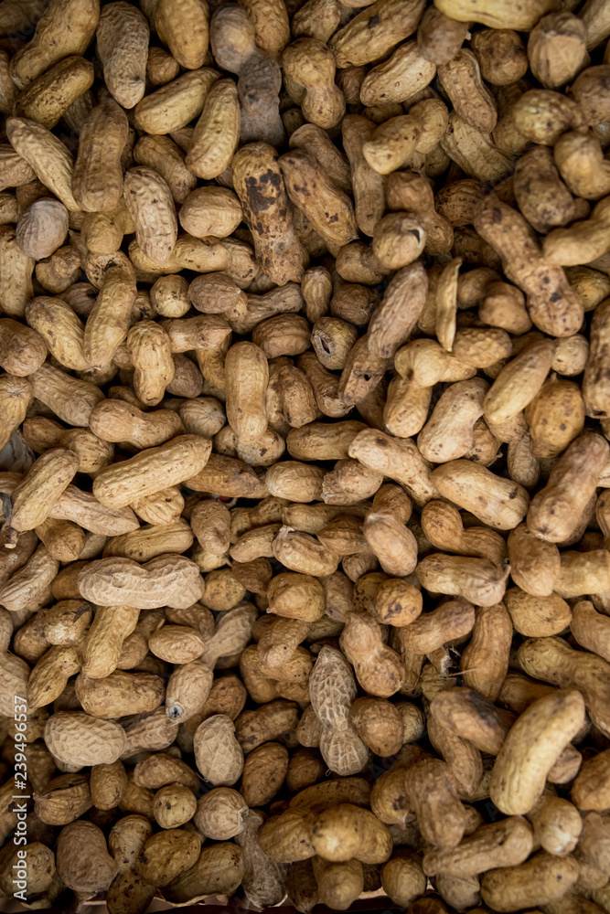 Peanuts in shell texture background. Raw peanuts on display at a farmer Peanuts in shell texture background. Raw peanuts on display at a farmer