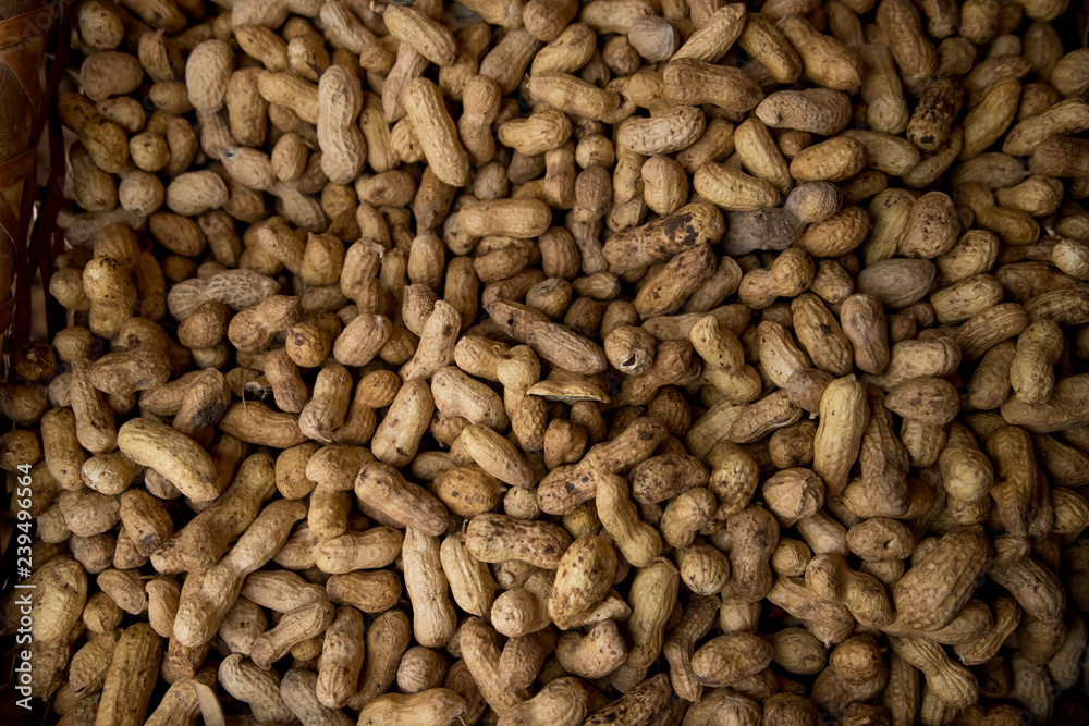 Peanuts in shell texture background. Raw peanuts on display at a farmer Peanuts in shell texture background. Raw peanuts on display at a farmer