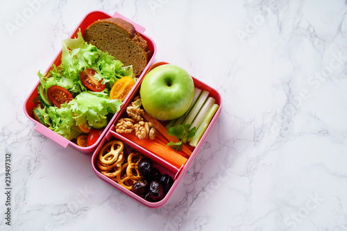 Lunch box with salad and healthy food for work and school