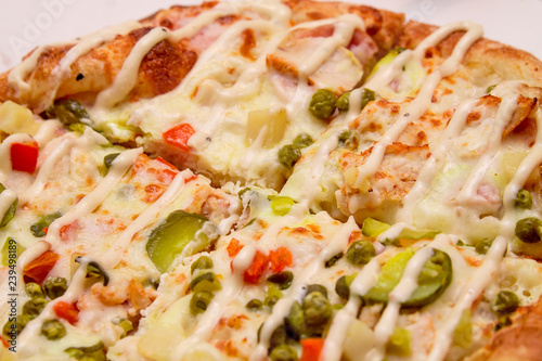 Close up: Delicious Pizza with Mozarella, Pickles, Cheese, Beef, Chilli Jalapeno Pepper, Olive, Green Pepper and Tomato