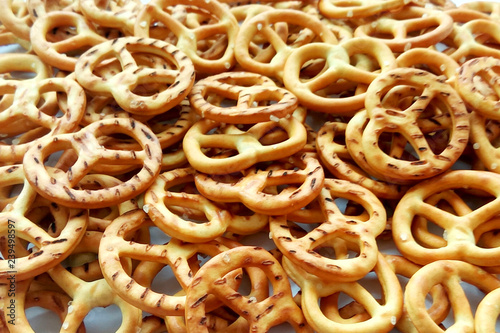 Salty crispy cracker mini pretzels on wooden background. Close up photography