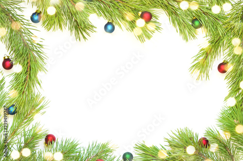 Christmas frame made from pine branch and ornaments on white background.
