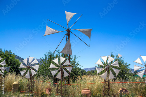 Old rusty windmills on the field. Agriculture in Greece, Crete photo