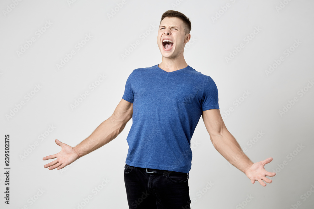 Ecstatic guy dressed in blue t-shirt is shouting Ecstatic guy dressed in blue t-shirt is shouting