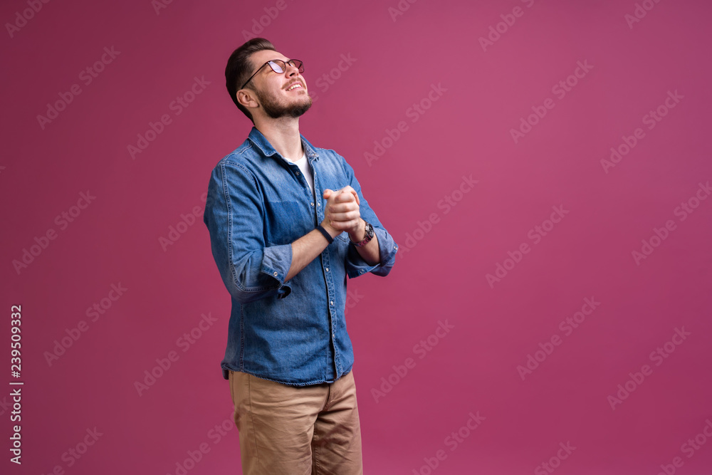 Portrait of a satisfied young man celebrating success isolated over pink background. Portrait of a satisfied young man celebrating success isolated over pink background.