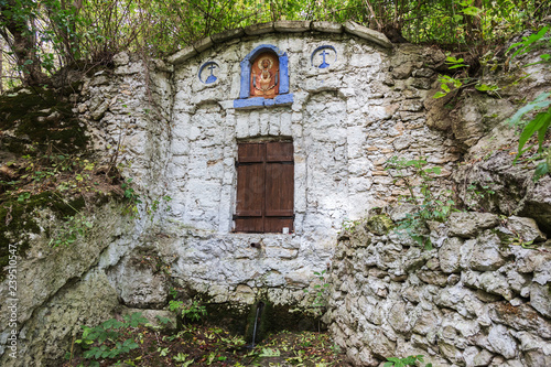 The holy spring of living water, the old 17th century font, moss-covered walls, autumn. Well of holy water with spring water, well known for its healing properties photo