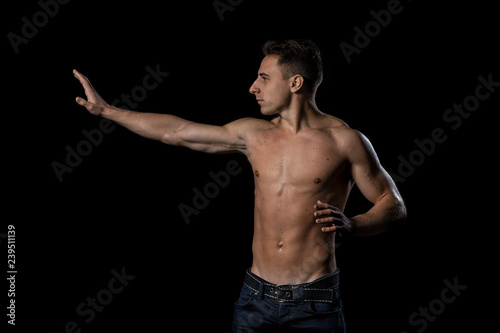 Portrait of young man over black background.