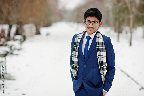 Stylish indian student man in suit, glasses and scarf posed at winter day outdoor. © AS Photo Family