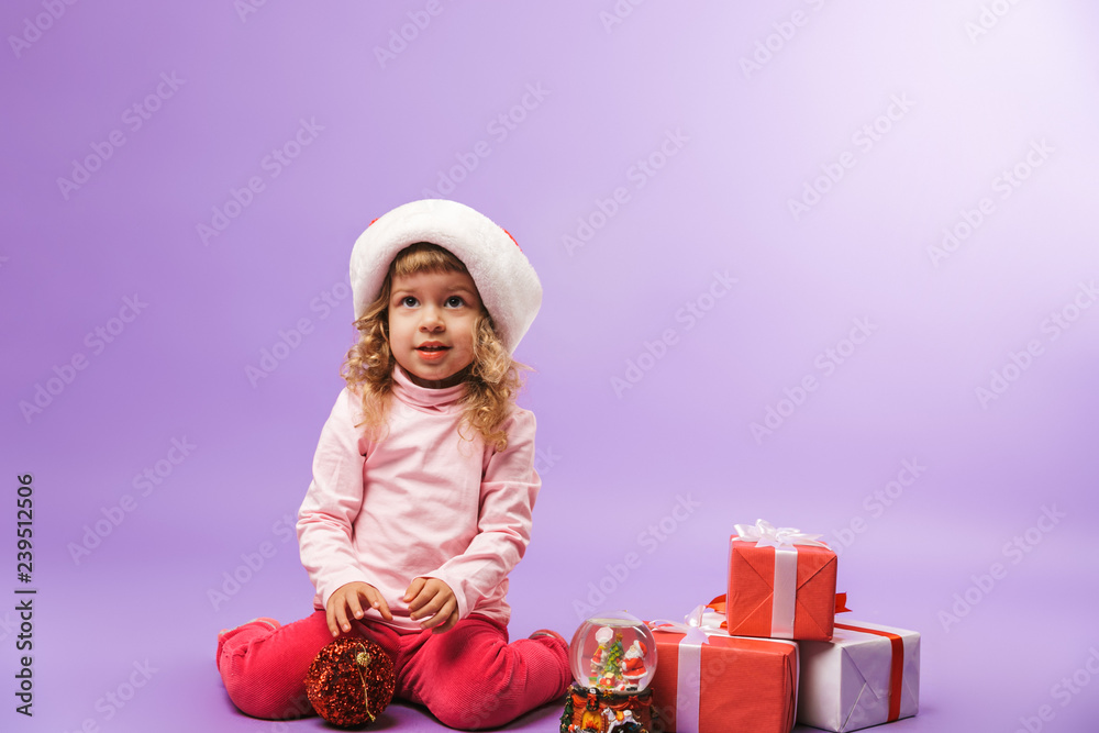 Cheerful little girl celebrating Christmas with presents Cheerful little girl celebrating Christmas with presents