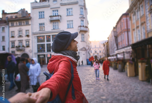 first person view of young woman in red jacket and gray cap walking on the street © vitaliymateha
