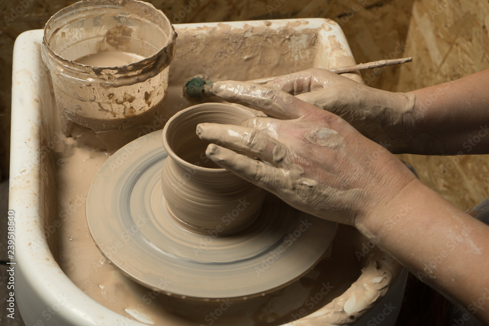 Master class on modeling of clay on a potter's wheel In the pottery workshop Master class on modeling of clay on a potter's wheel In the pottery workshop