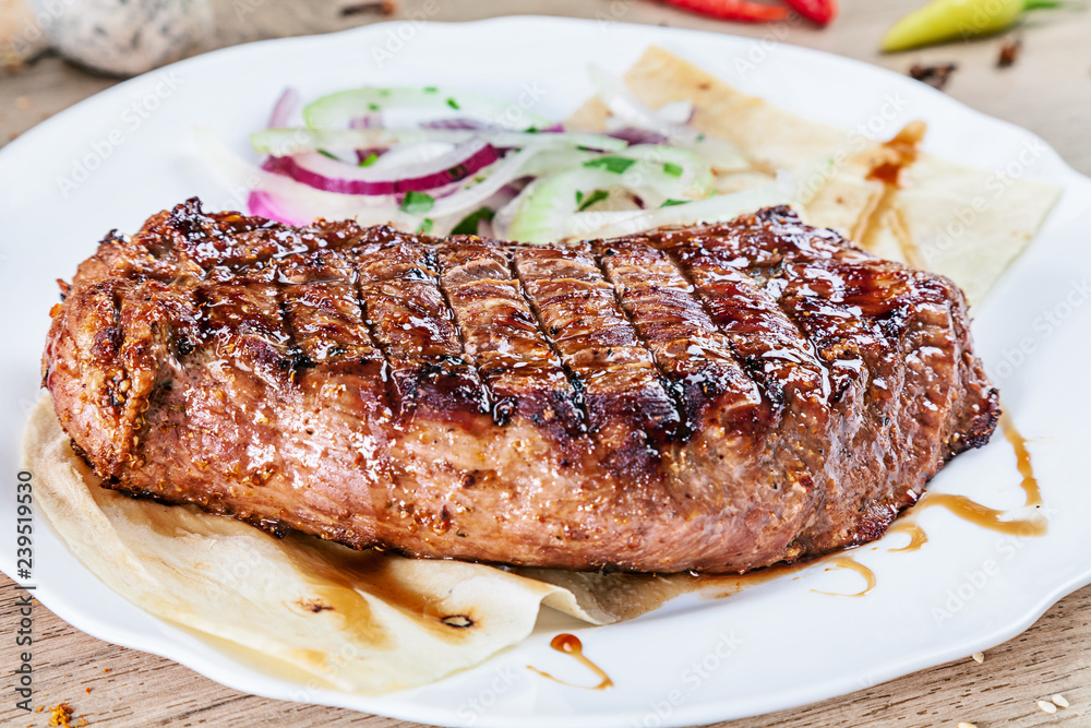 close up grilled beef fillet steak with herbs and spices on white plate. Meat, vegetables. Food for recipe. Tasty bbq cuisine. close up grilled beef fillet steak with herbs and spices on white plate. Meat, vegetables. Food for recipe. Tasty bbq cuisine.