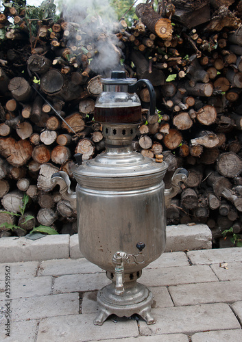 the samovar is heated against the stored wooden logs