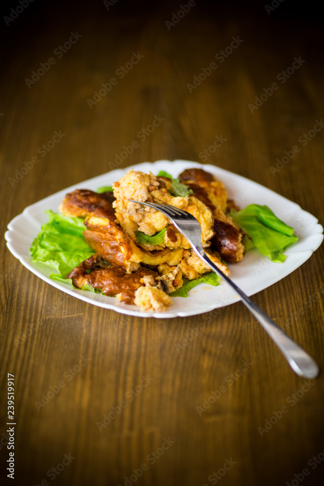 fried omelet with meat and greens in a plate fried omelet with meat and greens in a plate