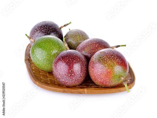 whole passion fruit in basket and on white background