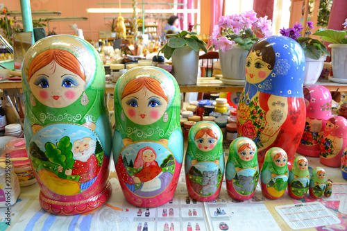NIZHNY NOVGOROD, RUSSIA - JUNE 15, 2014: Production of nesting dolls in Semenov city known for its famous Khokhloma painting photo