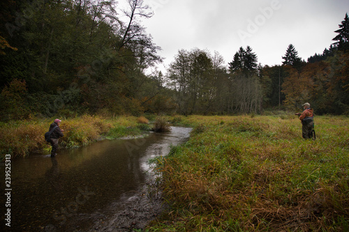 Two fly fishermen fishing for searun cutthroat trout on Chambers Creek near Tacoma, Washington USA photo