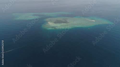 seascape aerial view coral reef, atoll with turquoise water in sea.Tropical atoll, coral reef in ocean waters. Travel concept. © Alex Traveler