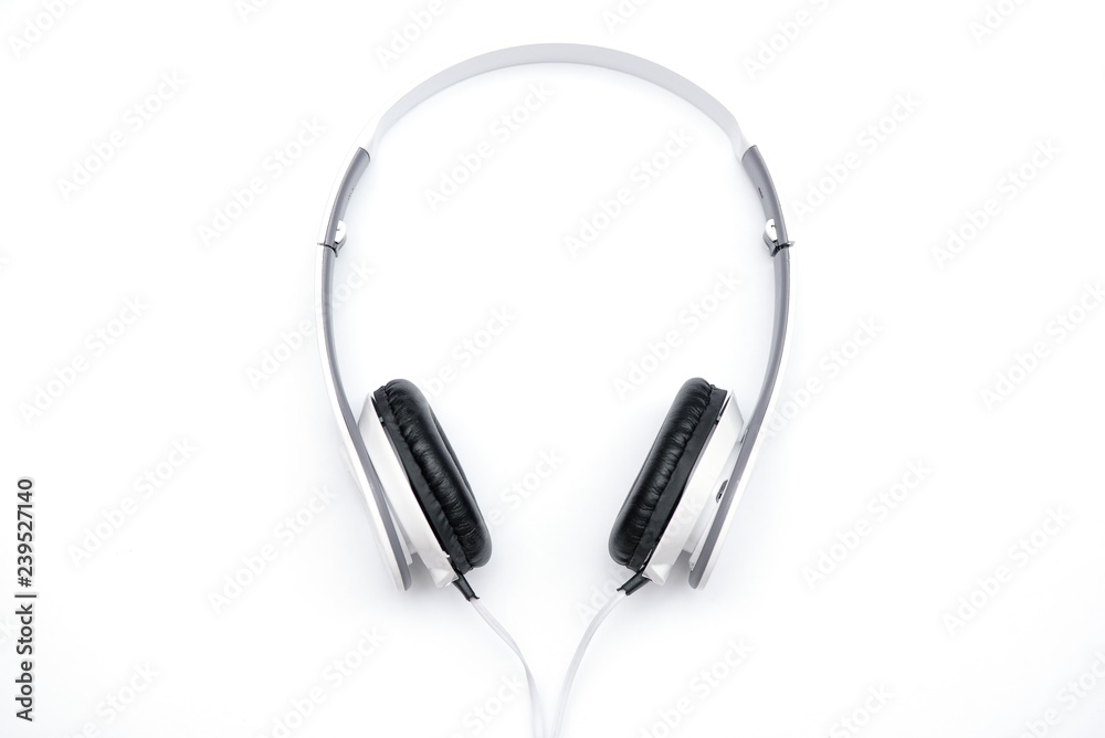 Lie white headphones on a white background. Lie white headphones on a white background.