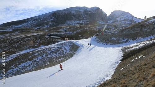 Footage of unidentified people skiing on a slope with artificial snow.