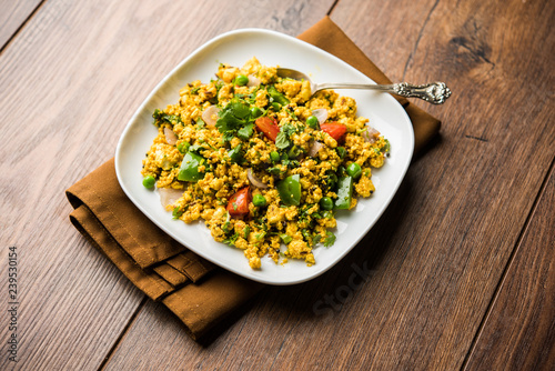 Paneer Bhurji, mildly spiced cottage cheese scramble and served with roti or laccha paratha, selective focus