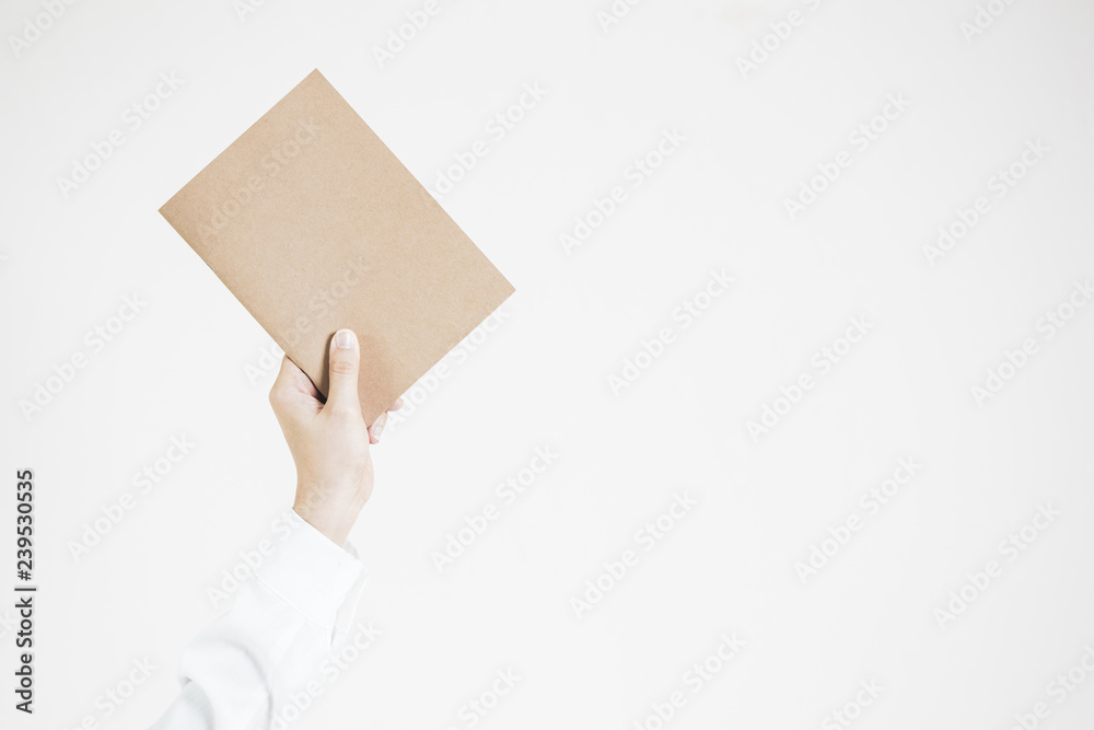 Business women in the white shirt holding an empty brown paper up on the white background.  Copy space on that meterial and right side for text and copy.