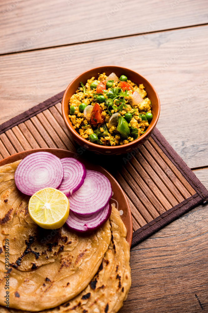 Paneer Bhurji, mildly spiced cottage cheese scramble and served with roti or laccha paratha, selective focus