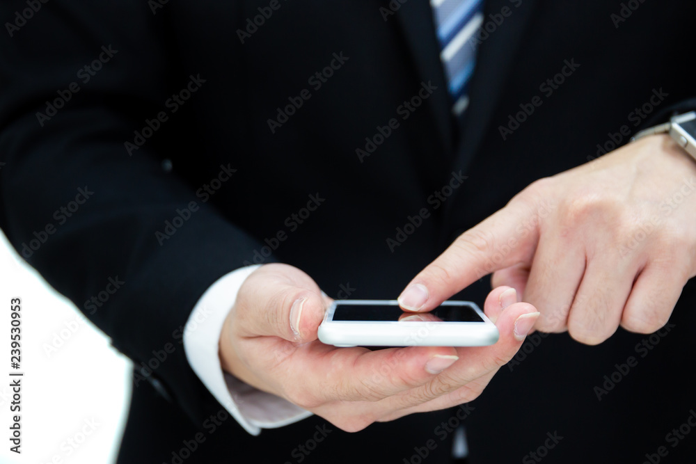 Portrait of business man in formal black suit tapping on a smartphones close up. Isolated on white background. Portrait of business man in formal black suit tapping on a smartphones close up. Isolated on white background.