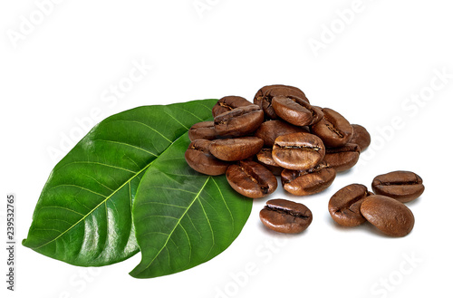 Roasted coffee beans and green leaves isolated on white background