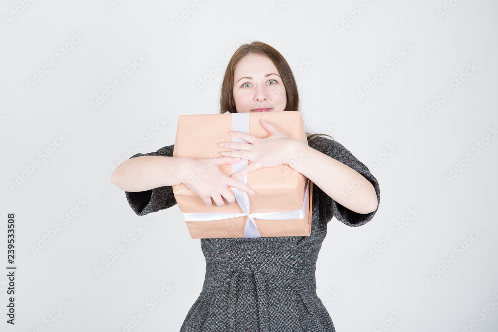 Portrait of a happy young woman in sunglasses isolated, holding present box Portrait of a happy young woman in sunglasses isolated, holding present box