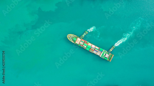 Container ship in export and import business logistics and transportation. Cargo and container box shipping to harbor by crane. Water transport International. Aerial view and top view. © MAGNIFIER