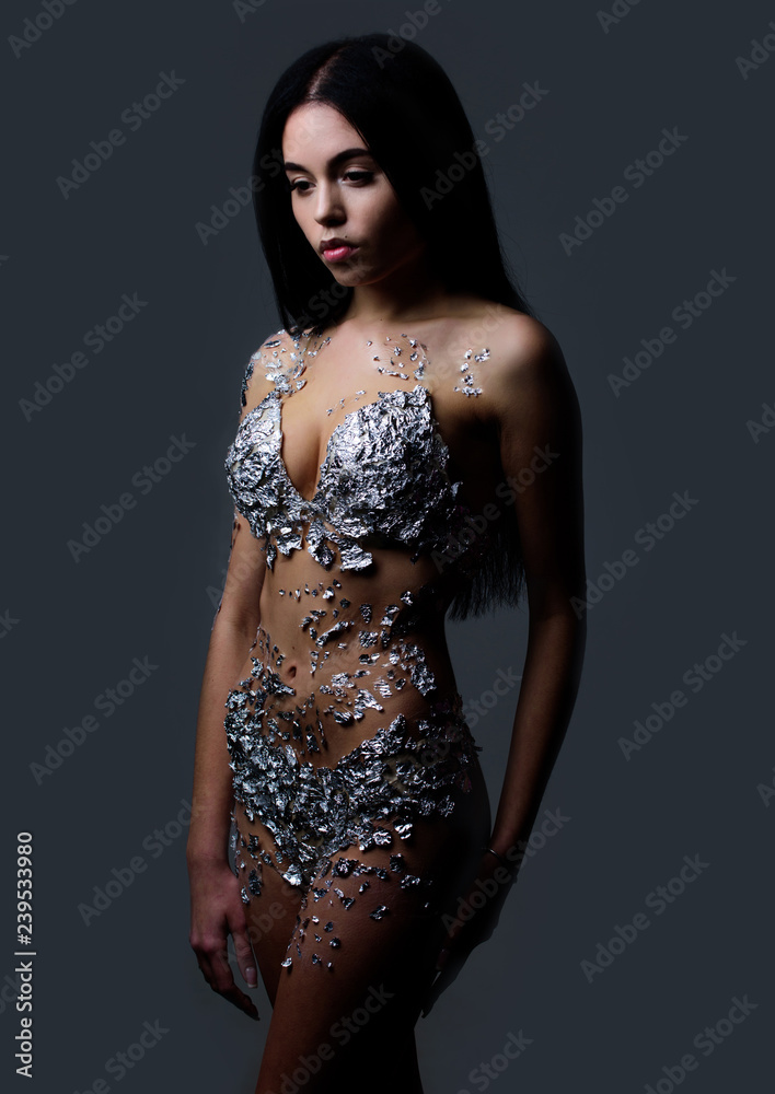 Foto Stock Woman attractive slim girl wear lingerie. Sexy body covered with  rhinestones. Bra and panties made out of rhinestones. Sexy fashion lingerie.  Shimmering silver lingerie. Fashionable female lingerie | Adobe Stock