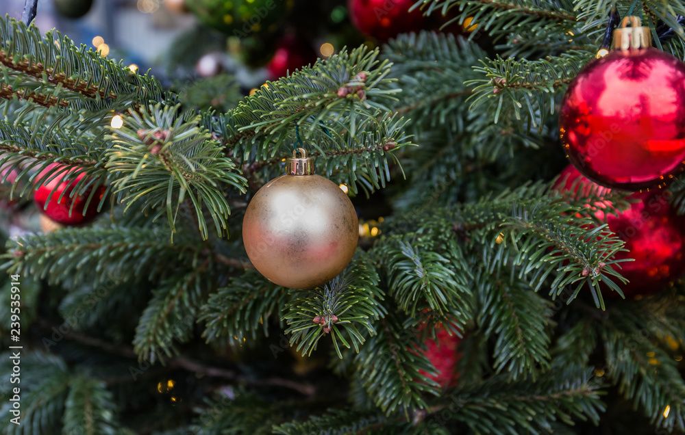 Christmas tree closeup. Red and golden balls and illuminated garland with flashlights. Christmas tree closeup. Red and golden balls and illuminated garland with flashlights.