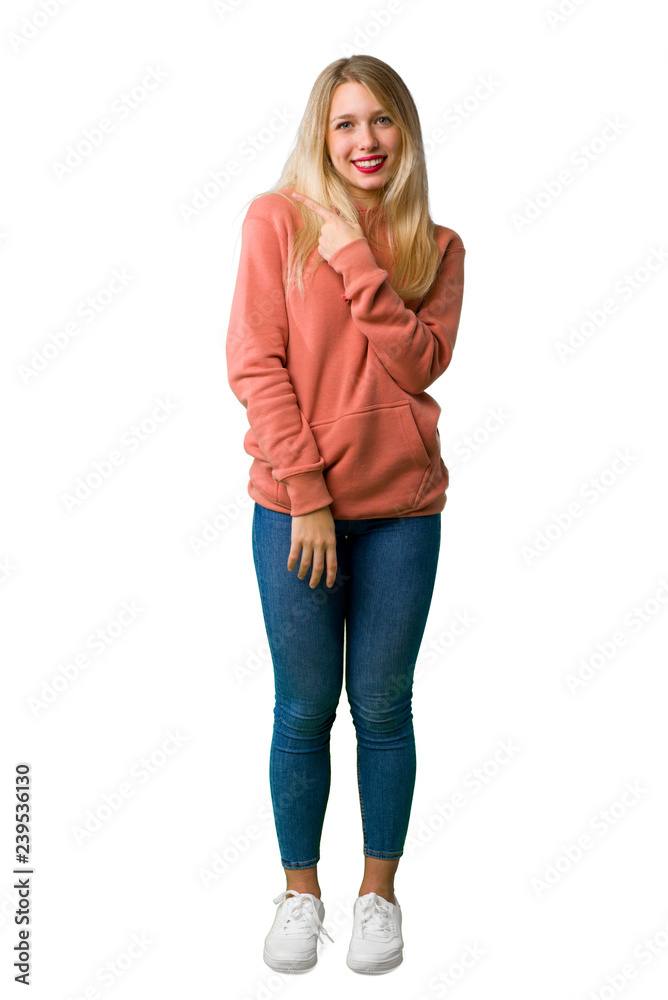 A full-length shot of a Young girl pointing to the side to present a product on isolated white background A full-length shot of a Young girl pointing to the side to present a product on isolated white background