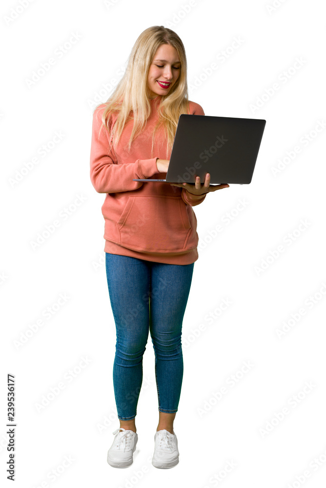 A full-length shot of a Young girl with laptop on isolated white background A full-length shot of a Young girl with laptop on isolated white background