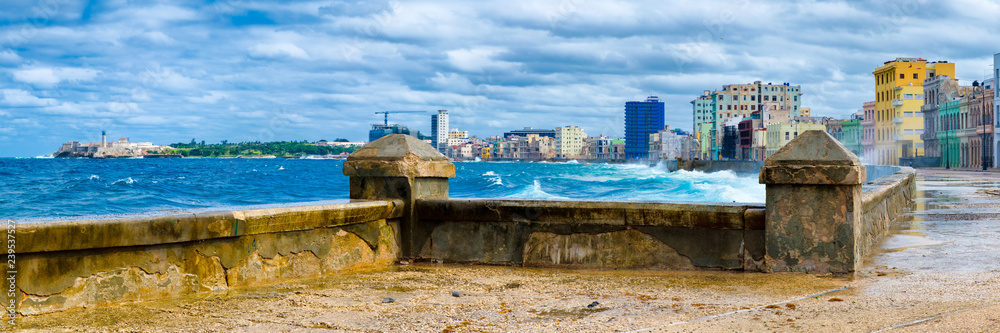 Fototapeta premium The Havana skyline and the iconic Malecon seawall with a stormy ocean