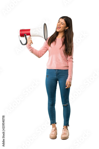 A full-length shot of a Teenager girl with pink shirt taking a megaphone that makes a lot of noise