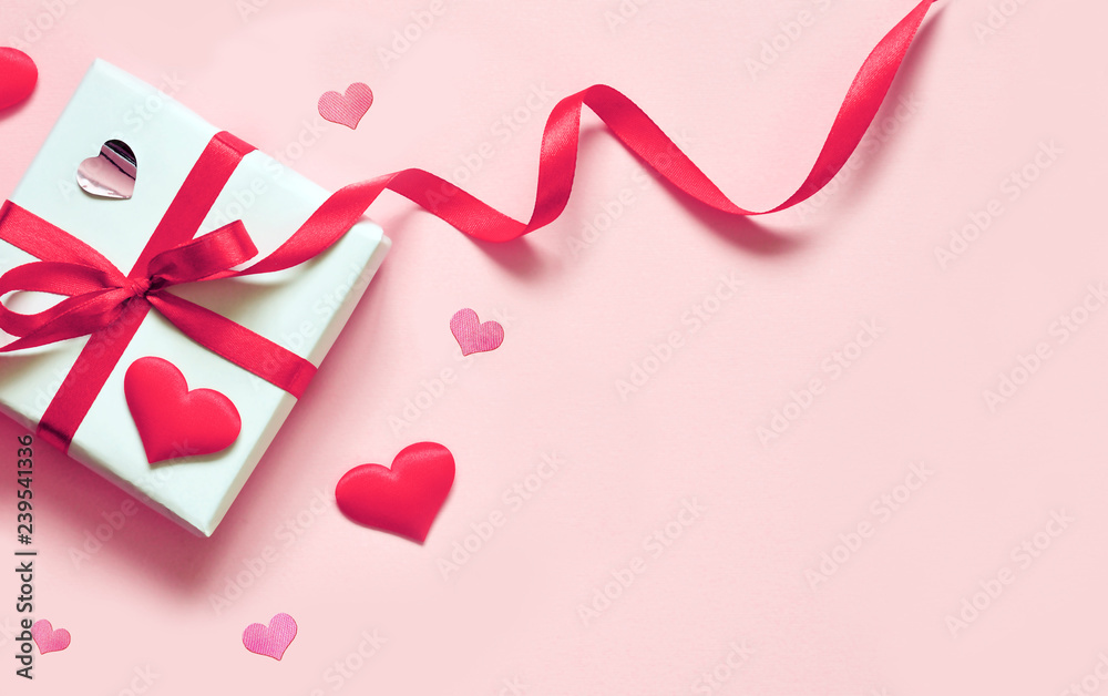 Valentine day composition: white gift box with bow and hearts. Top View. View from above