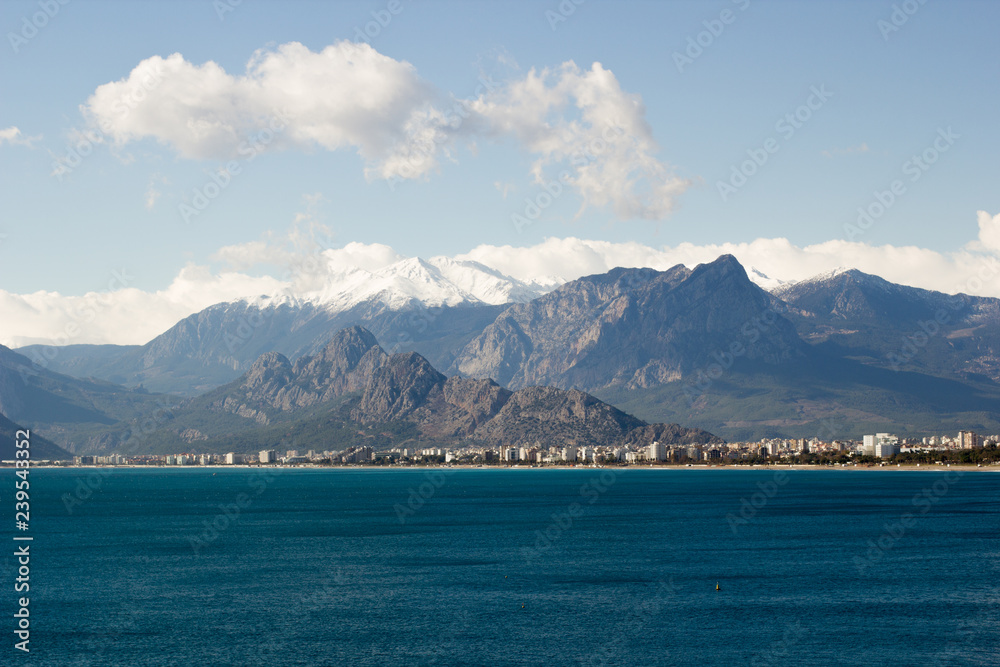 View of the Konyaalti district in the city of Antalya and the winter mountains