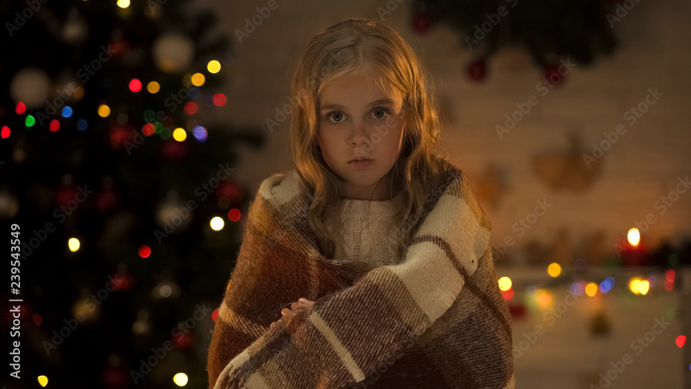 Abandoned girl with plaid looking to camera waiting new family, X-mas time Abandoned girl with plaid looking to camera waiting new family, X-mas time
