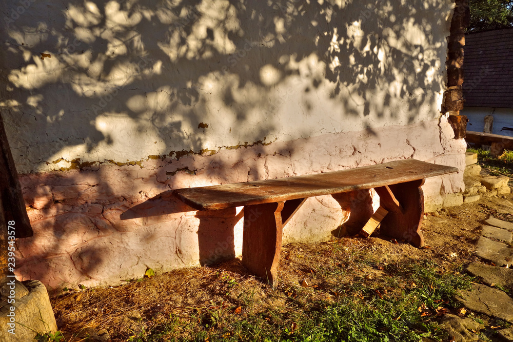 Wooden bench next to the old house Wooden bench next to the old house