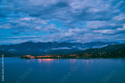 Panoramic view of Corsica mountains and city of Calvi on the cloudy evening