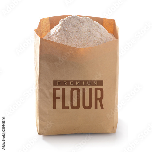 Whole flour in paper bag isolated on white background photo