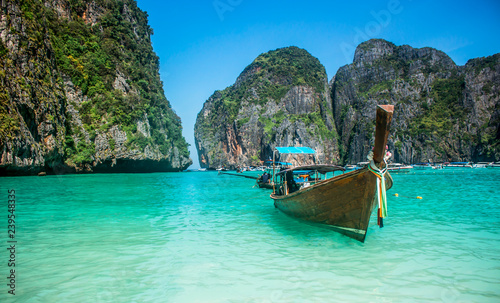 Long-tail boat floating in transparent water of Maya Bay beach, the paradise island.
