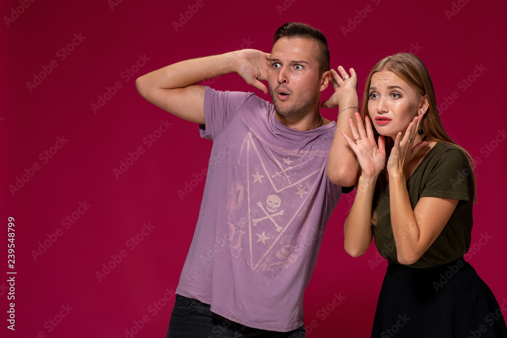 Unhappy discontent woman and man look with disgusting expression, as see something unpleasant. Awkward couple Unhappy discontent woman and man look with disgusting expression, as see something unpleasant. Awkward couple